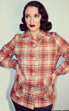 Model wearing a red and beige plaid jacket Model wearing a red and beige plaid jacket