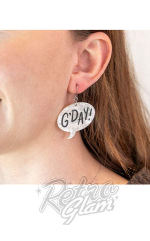 Earring with 'G'DAY!' design worn by a person, with 'Retina Glam' branding. Earring with 'G'DAY!' design worn by a person, with 'Retina Glam' branding.