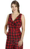 A woman modeling a red and black buffalo plaid sleeveless wrap-style jumpsuit