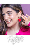 Woman wearing a red heart-shaped earring with 'LOVE' text