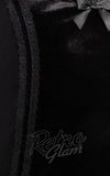 Close-up of a black velvet garment with black lace trim and bow alternative apparel